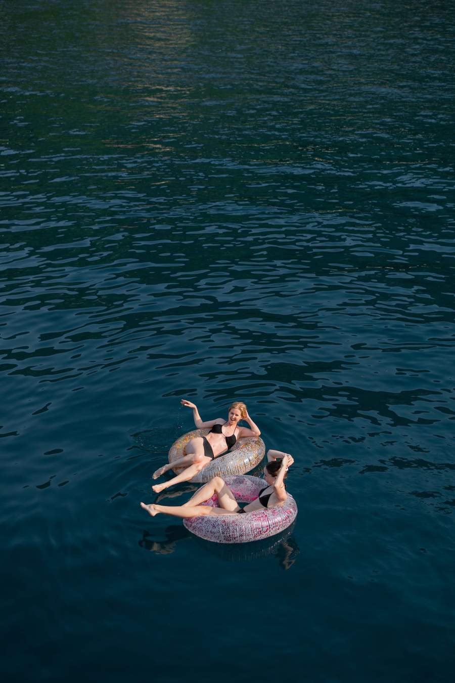 Inflatable floats next to the yacht — family-friendly water activities