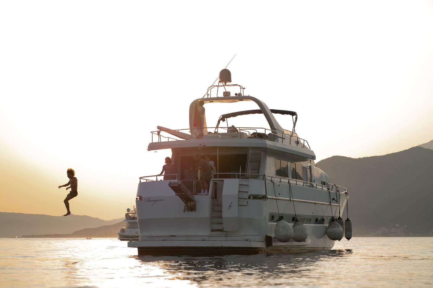 Our yacht cruising at golden hour along the Montenegrin coast